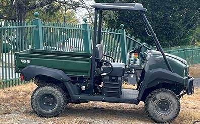 A vehicle parked on a dirt road

Description automatically generated