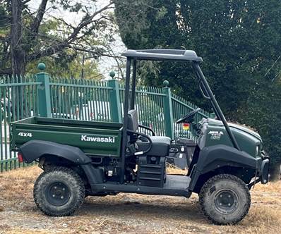 A small vehicle parked in a field

Description automatically generated