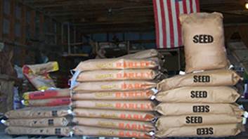 A stack of bags of grain

Description automatically generated