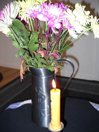 A bouquet of flowers in a vase on a table

Description automatically generated